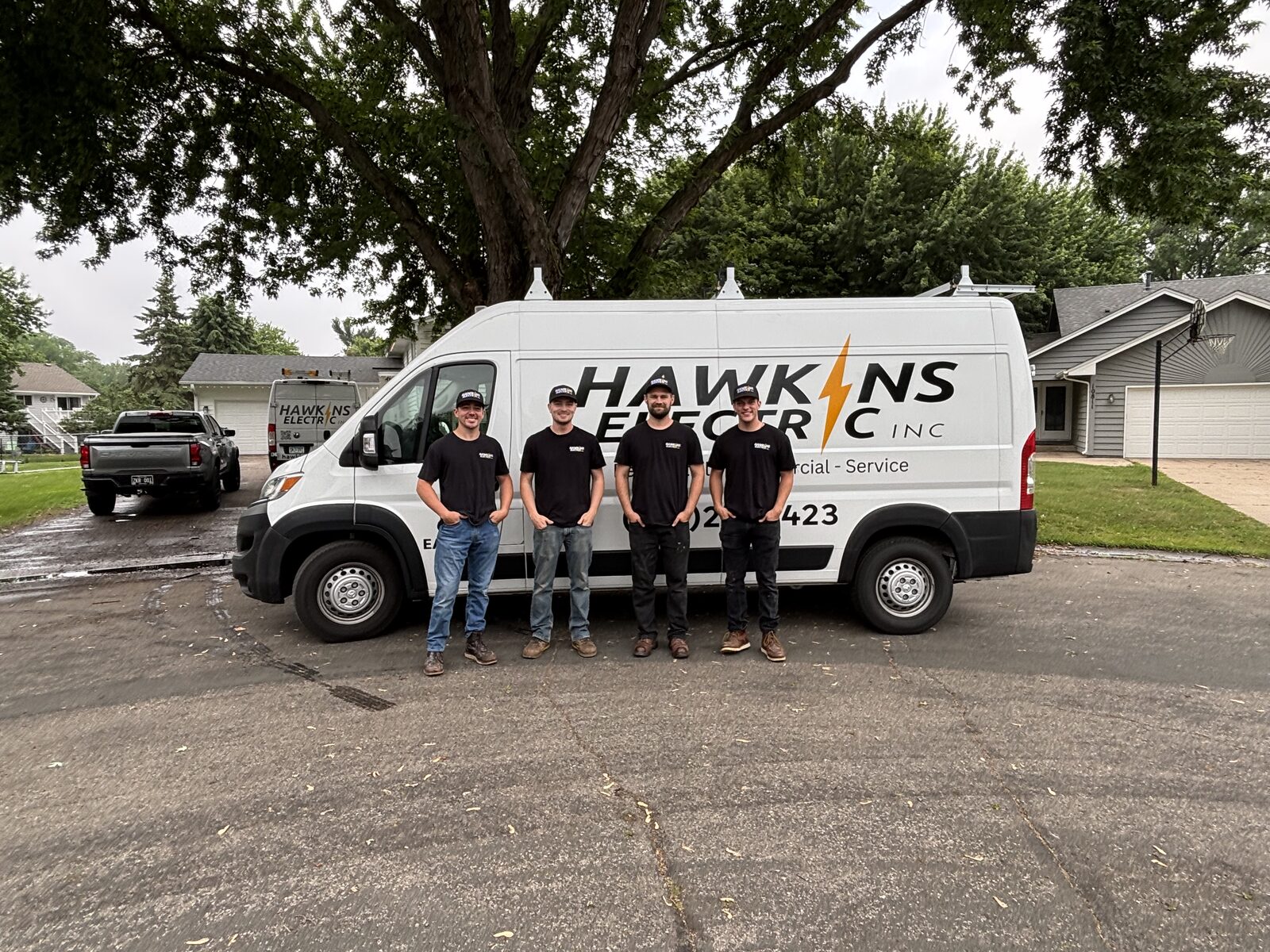The Hawkins Electric crew standing in front of their service van